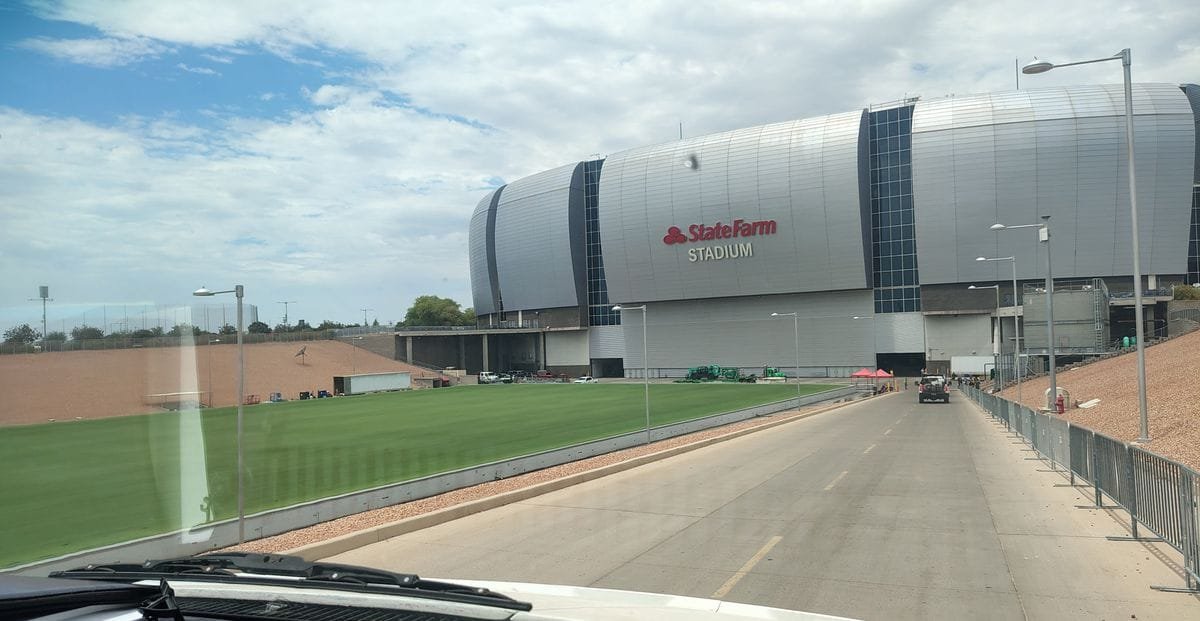 Pulling up to State Farm Stadium for a job, seen from the cab
